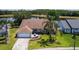 Aerial view of a single story home overlooking a beautiful lake and serene landscaping at 1949 Tiptree Cir, Orlando, FL 32837