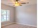 Bright bedroom featuring a neutral color scheme, tile flooring, a ceiling fan, and a window for natural light at 1949 Tiptree Cir, Orlando, FL 32837