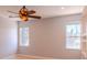 Neutral bedroom featuring a ceiling fan and two windows that provide natural light at 1949 Tiptree Cir, Orlando, FL 32837