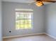 Bright bedroom featuring a neutral color scheme, tile flooring, a ceiling fan, and large window for natural light at 1949 Tiptree Cir, Orlando, FL 32837