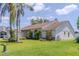 View of the side of the home, showcasing its architectural style, landscaping, and well-maintained lawn at 1949 Tiptree Cir, Orlando, FL 32837