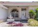 Close-up view of the front door, detailed window, and water feature enhancing curb appeal at 1949 Tiptree Cir, Orlando, FL 32837