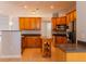 Well-lit kitchen featuring wooden cabinets, an island and stainless-steel appliances at 1949 Tiptree Cir, Orlando, FL 32837