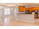 Open-concept kitchen with wood cabinets, breakfast bar, and view into the adjacent living areas at 1949 Tiptree Cir, Orlando, FL 32837