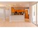 Spacious kitchen flows into the living area and features wooden cabinets and stainless appliances at 1949 Tiptree Cir, Orlando, FL 32837