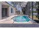 Sunlit view of the screened in pool with access to the house at 1949 Tiptree Cir, Orlando, FL 32837