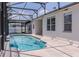 Pool view inside the screened in area, featuring a uniquely shaped pool design at 1949 Tiptree Cir, Orlando, FL 32837