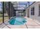 View of the pool inside screened in area, featuring waterfront views and a pool cleaning robot at 1949 Tiptree Cir, Orlando, FL 32837