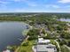 Breathtaking aerial view of lakeside properties, waterfront access, lush greenery, and city skyline in the distance at 195 E Faith Ter, Maitland, FL 32751