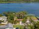 Aerial view showcasing a lakefront home with lush landscaping and a tranquil lake at 195 E Faith Ter, Maitland, FL 32751