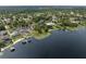 Picturesque aerial perspective of a lakefront community, highlighting waterfront access, docks, and serene ambiance at 195 E Faith Ter, Maitland, FL 32751