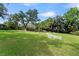 Spacious backyard featuring lush green lawn, tall trees, and potential for outdoor activities and entertaining at 195 E Faith Ter, Maitland, FL 32751