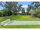 Expansive backyard featuring a shuffleboard court, mature trees, and outdoor seating area at 195 E Faith Ter, Maitland, FL 32751
