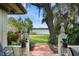Inviting backyard view featuring brick pathway to a green lawn, mature trees, and serene lakefront scenery at 195 E Faith Ter, Maitland, FL 32751