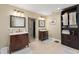 Bathroom featuring dual vanities, decorative mirrors, and a neutral color palette at 195 E Faith Ter, Maitland, FL 32751