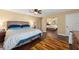 Comfortable bedroom with mirrored closet doors, a ceiling fan, and warm wood floors at 195 E Faith Ter, Maitland, FL 32751
