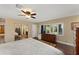 Bedroom with wood floors, a ceiling fan, and large windows offering backyard views at 195 E Faith Ter, Maitland, FL 32751