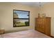 Bedroom featuring a window with lake views, a wooden dresser, and neutral paint at 195 E Faith Ter, Maitland, FL 32751