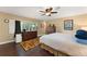 Cozy bedroom with a ceiling fan, a large window, and warm wood floors at 195 E Faith Ter, Maitland, FL 32751