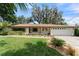 Charming one-story home with manicured lawn, mature trees and a two car garage at 195 E Faith Ter, Maitland, FL 32751