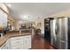 Spacious kitchen with stainless steel refrigerator and dark wood floors overlooking the living area at 195 E Faith Ter, Maitland, FL 32751