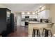 Well-lit kitchen with white cabinets, stainless steel appliances and a breakfast bar at 195 E Faith Ter, Maitland, FL 32751