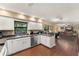 Open kitchen with white cabinets and stainless steel appliances, connecting to the living area at 195 E Faith Ter, Maitland, FL 32751