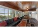Relaxing sunroom with floor-to-ceiling windows showcasing lake views and comfortable seating at 195 E Faith Ter, Maitland, FL 32751