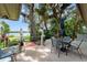 Charming outdoor patio with brick pavers, shaded seating area, and scenic lake views surrounded by lush trees at 195 E Faith Ter, Maitland, FL 32751