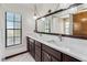 Bathroom features double sinks, marble countertops, a decorative mirror, and updated lighting at 2007 Peach Tree Blvd, St Cloud, FL 34769