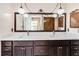 Bathroom with double sinks, marble countertops, pendant lighting, and a framed vanity mirror at 2007 Peach Tree Blvd, St Cloud, FL 34769