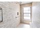 Tiled shower features a built-in bench seat, grab bars, and a window for ample natural light at 2007 Peach Tree Blvd, St Cloud, FL 34769