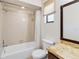 Bathroom featuring a tub, toilet, vanity with a cream countertop and dark wood cabinets at 2007 Peach Tree Blvd, St Cloud, FL 34769