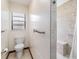 Bright bathroom with toilet, towel bar, and shower with built in bench and shower head at 2007 Peach Tree Blvd, St Cloud, FL 34769