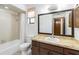 Bathroom featuring a vanity with brown cabinets, a white sink and toilet, and a shower with a curtain at 2007 Peach Tree Blvd, St Cloud, FL 34769