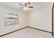 Bright bedroom featuring a ceiling fan, carpeted floor, and a window with blinds at 2007 Peach Tree Blvd, St Cloud, FL 34769