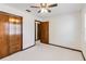 Bedroom with ceiling fan, carpet floors, and wood doors at 2007 Peach Tree Blvd, St Cloud, FL 34769
