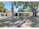 Charming single-story home featuring a manicured lawn and mature trees offering ample shade at 2007 Peach Tree Blvd, St Cloud, FL 34769