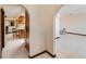 Hallway with white tile floors leading to kitchen and living spaces with arched doorways at 2007 Peach Tree Blvd, St Cloud, FL 34769