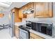 Updated kitchen with stainless steel appliances and warm wood cabinetry offers modern conveniences at 2007 Peach Tree Blvd, St Cloud, FL 34769