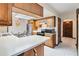 Kitchen offers a breakfast bar, white countertops, stainless steel appliances and light wood cabinetry at 2007 Peach Tree Blvd, St Cloud, FL 34769