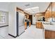 Well-lit kitchen with stainless steel appliances, wood cabinets, and tile flooring at 2007 Peach Tree Blvd, St Cloud, FL 34769