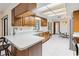 Bright kitchen features wood cabinets, white countertops, stainless steel appliances and a breakfast bar at 2007 Peach Tree Blvd, St Cloud, FL 34769