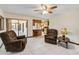 Inviting living room with ceiling fan, tiled floor and view of the kitchen at 2007 Peach Tree Blvd, St Cloud, FL 34769
