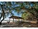 Outdoor pavilion offers a serene setting with picnic tables, shaded by mature trees, near the sandy beach at 2007 Peach Tree Blvd, St Cloud, FL 34769