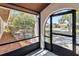 Relaxing screened-in porch with an arched doorway and a view of the front yard at 2007 Peach Tree Blvd, St Cloud, FL 34769
