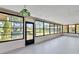 Enclosed sunroom featuring a traditional hanging lamp, large window views of backyard, and a door to the backyard at 2007 Peach Tree Blvd, St Cloud, FL 34769