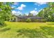 Spacious backyard featuring lush greenery and a screened-in pool area for outdoor enjoyment at 2108 Silver Leaf Ct, Longwood, FL 32779