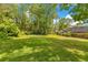 Expansive backyard with lush lawn and mature trees offers privacy and space for outdoor activities at 2108 Silver Leaf Ct, Longwood, FL 32779