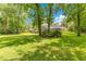 Large backyard features a well-maintained lawn and established landscaping around the beautiful home at 2108 Silver Leaf Ct, Longwood, FL 32779